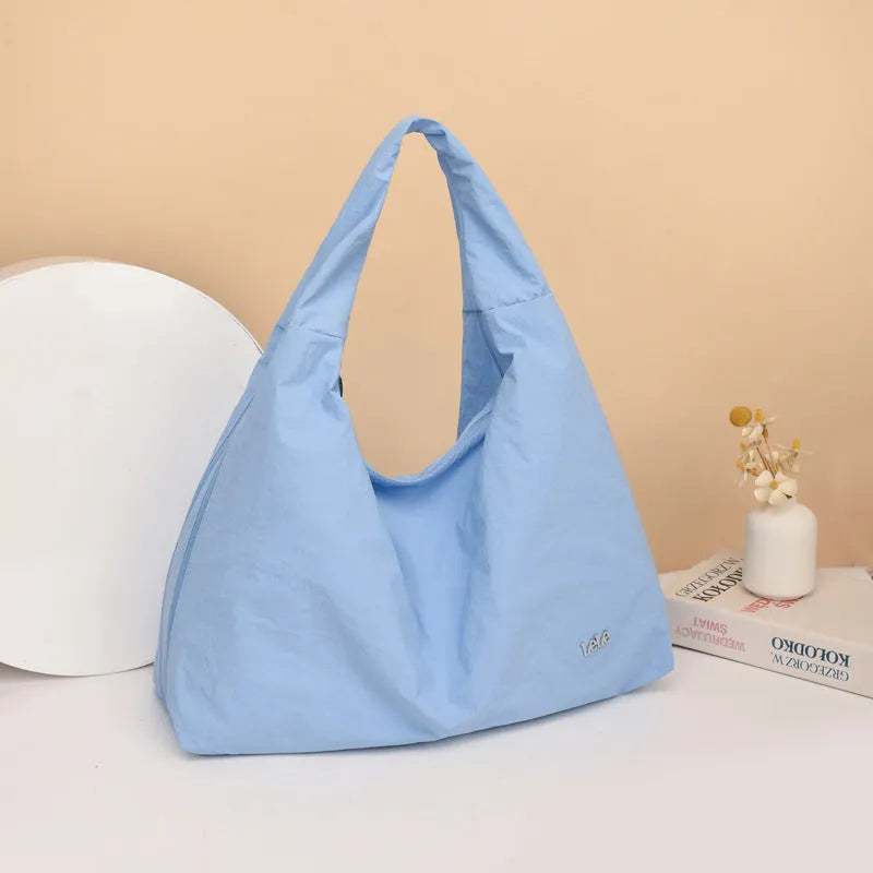 Heart-shaped soft nylon underarm shoulder bag for women in black, blue, khaki, or yellow.