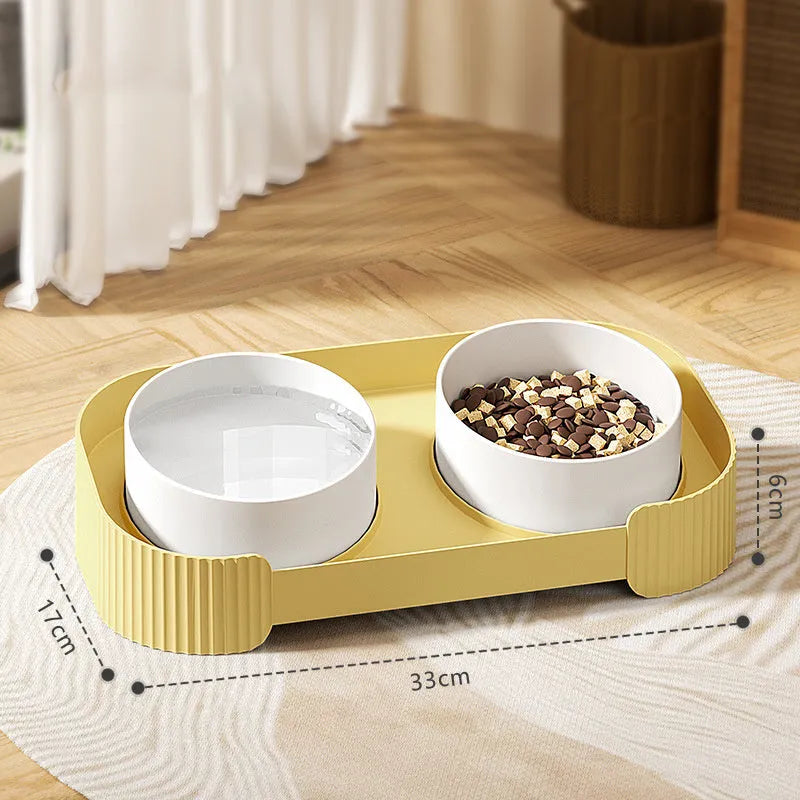 Green ceramic raised cat feeder with two tilted bowls on a non-slip white stand.