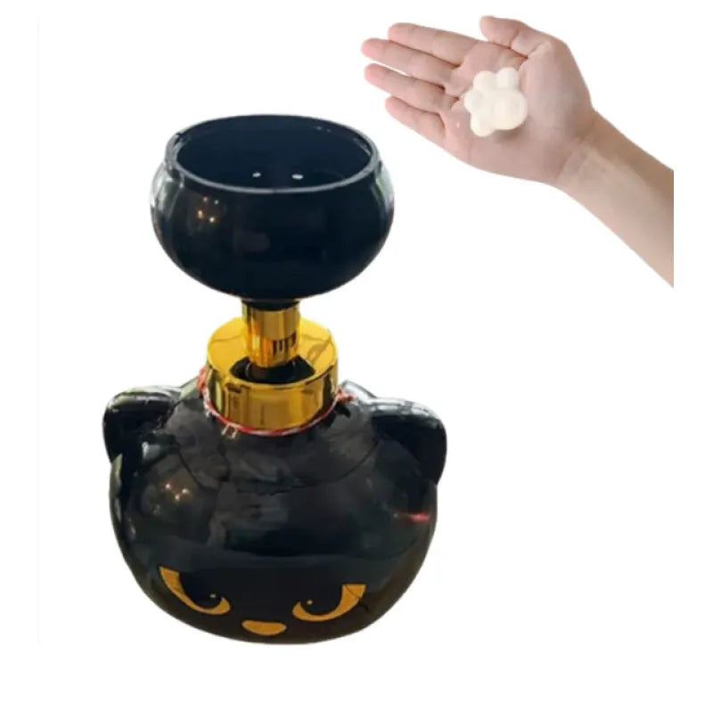 Black plastic cartoon cat-shaped manual soap dispenser on a countertop.