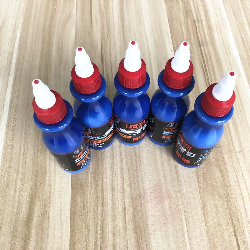 Blue car scratch repair agent container with microfiber cloth for minor automotive surface imperfections