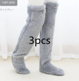 Cozy over-the-knee fuzzy socks in various colors, including brown, blue, dark gray, pink, silver, and more. Comfortable cotton design for warm, snug legs.