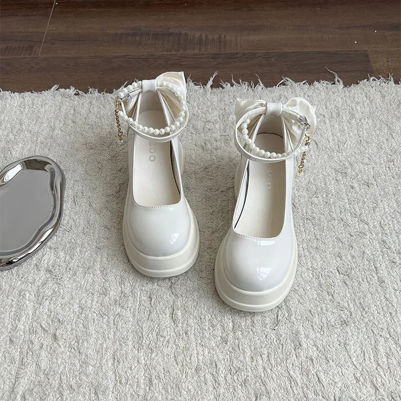 Women's beige chunky heel Mary Jane pumps with round toe and shallow mouth strap.