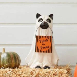 A ghostly dog figure carrying a large pumpkin candy bowl, an eerie and whimsical Halloween decoration for your home