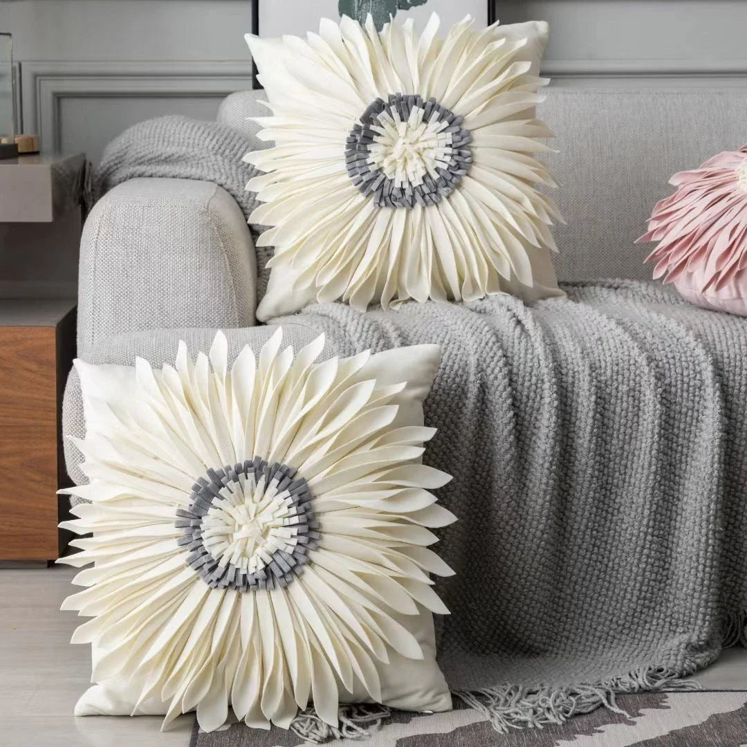 Stylish velvet throw pillows with 3D chrysanthemum embellishments in blue, yellow, pink, and white colors