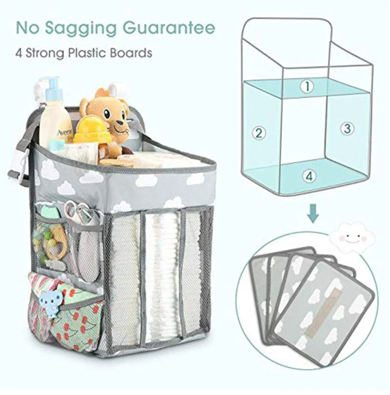 Portable baby crib organizer with hanging storage pockets for diapers, bottles, toys, and other nursery essentials