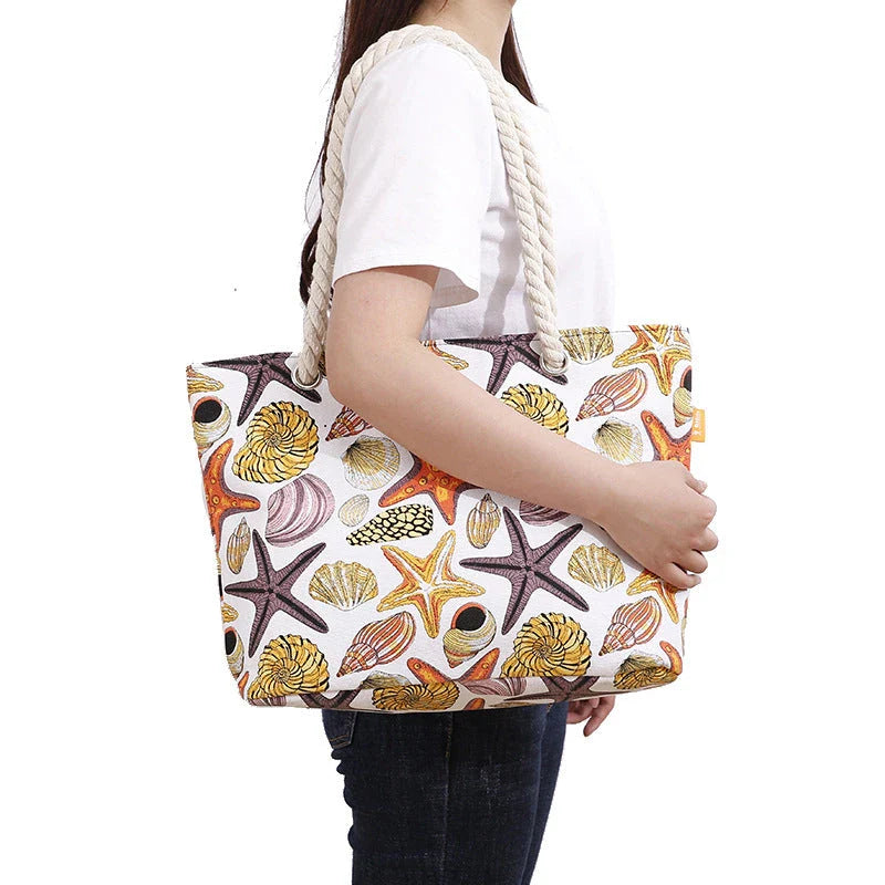Stylish canvas beach tote bag with a charming Shells Conch print, perfect for summer adventures and everyday use.