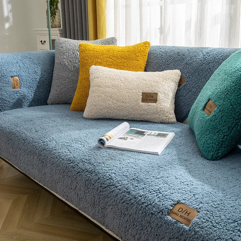 Beige lamb wool plush sofa cover with anti-slip backing on a grey fabric sofa.