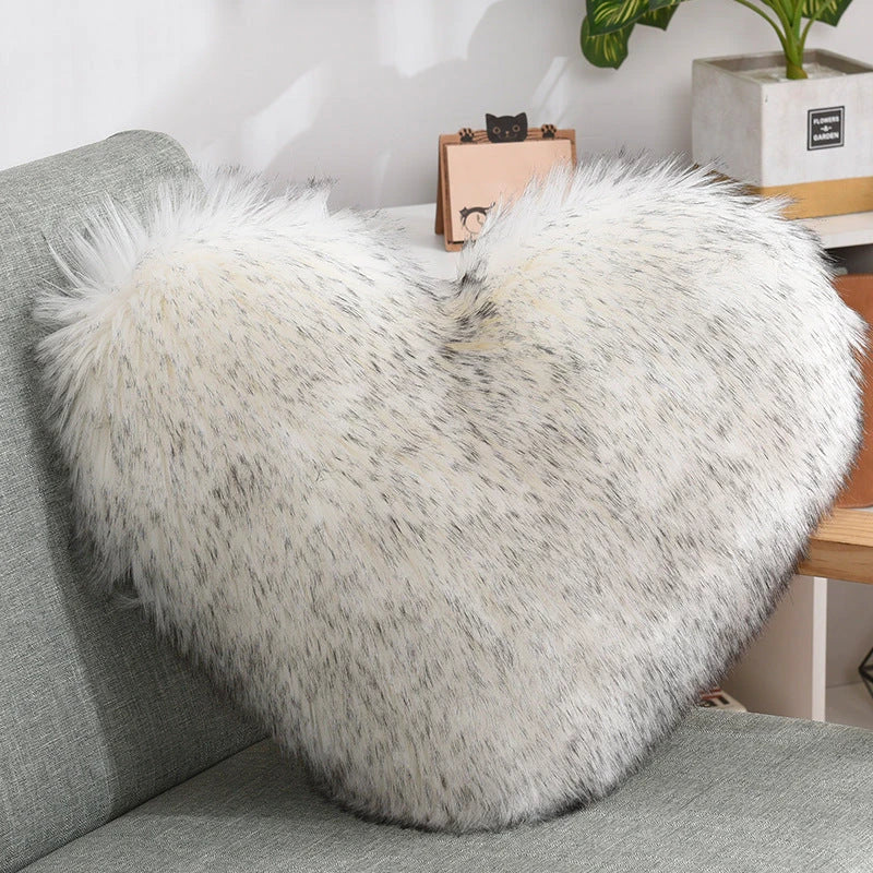 Cozy heart-shaped plush throw pillows in various colors and sizes for living room and bedroom decor