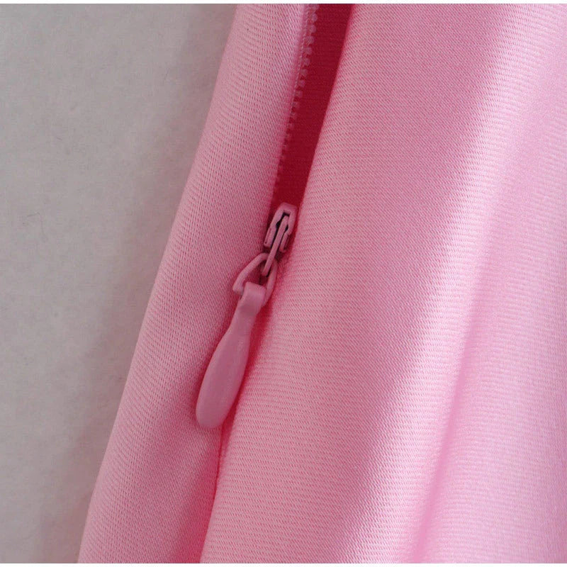 Elegant satin slip dress in pink with a flattering, form-fitting silhouette and sexy backless design