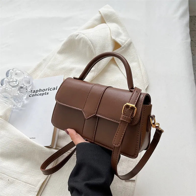 Women's beige messenger bag with horizontal square design showing file compartment and exterior pocket