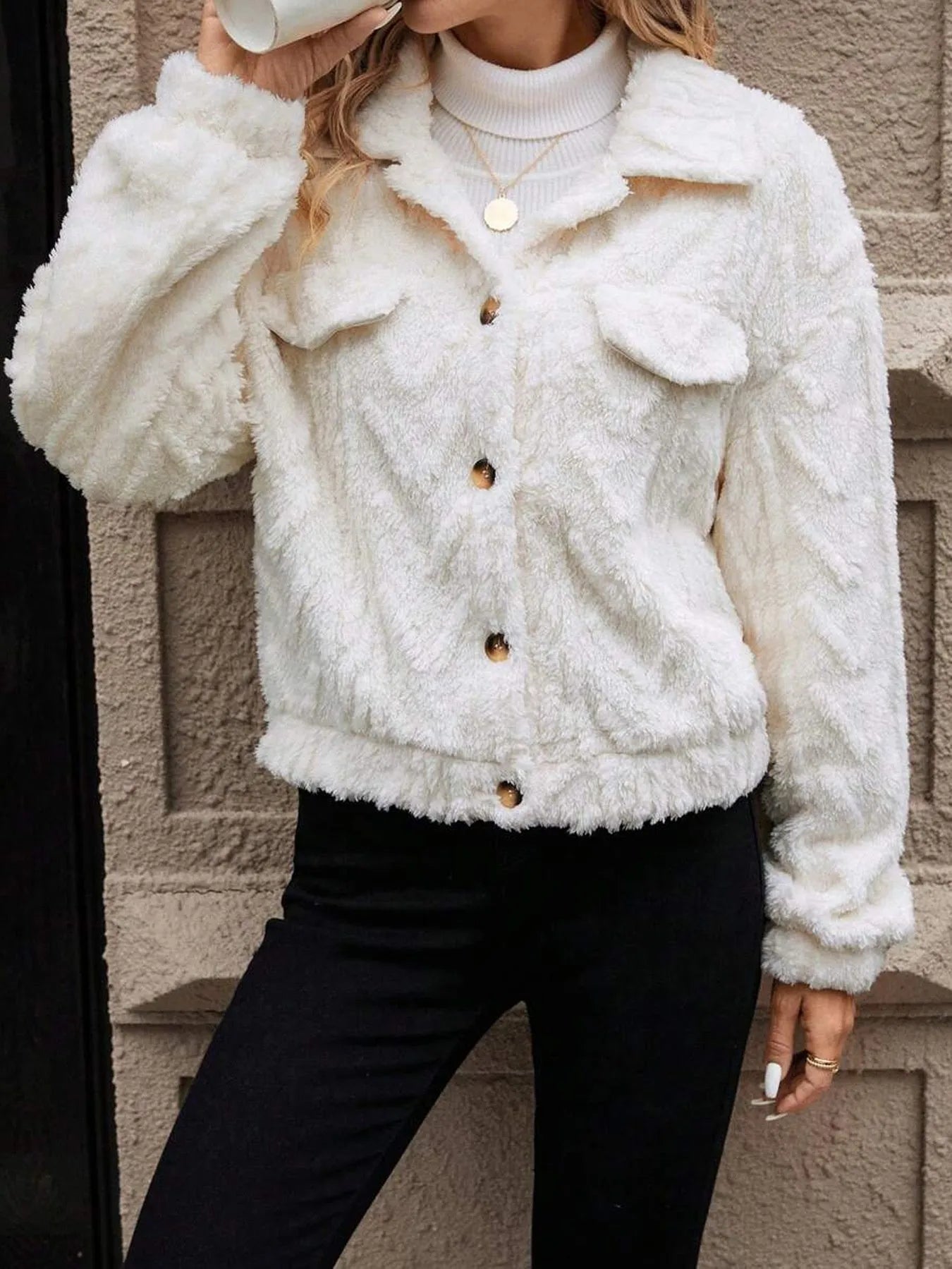 Ivory white women's double-sided plush button-front cardigan coat on a hanger.