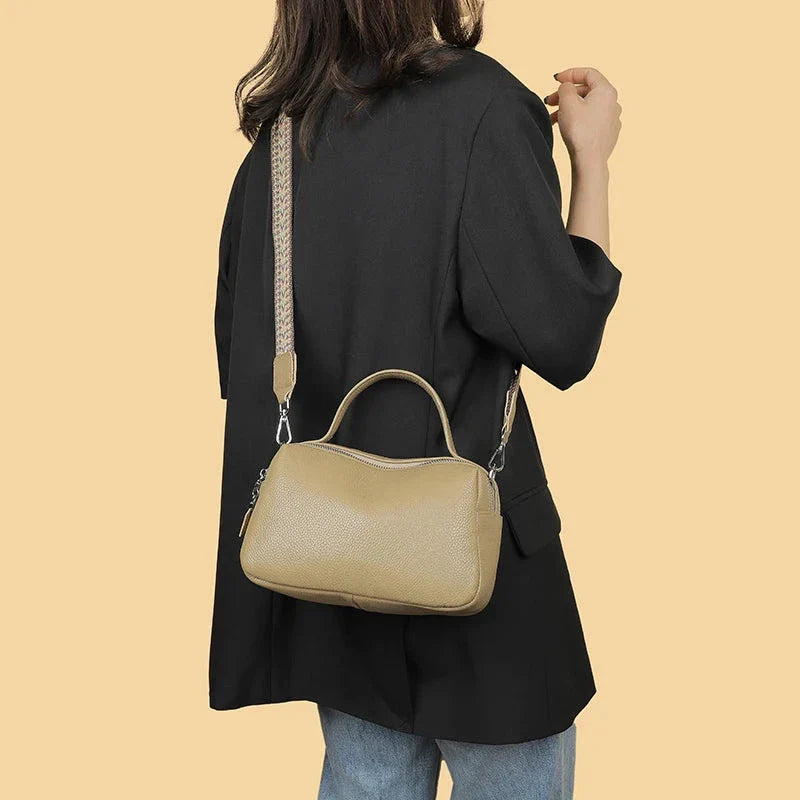 Luxurious genuine leather crossbody bag for women, featuring a soft, compact design with dedicated phone pockets and an adjustable strap for versatile wear.