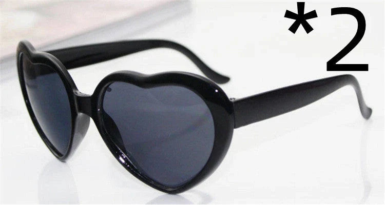 Stylish heart-shaped lighting sunglasses with a plastic frame and resin lenses, creating a mesmerizing effect for romantic occasions