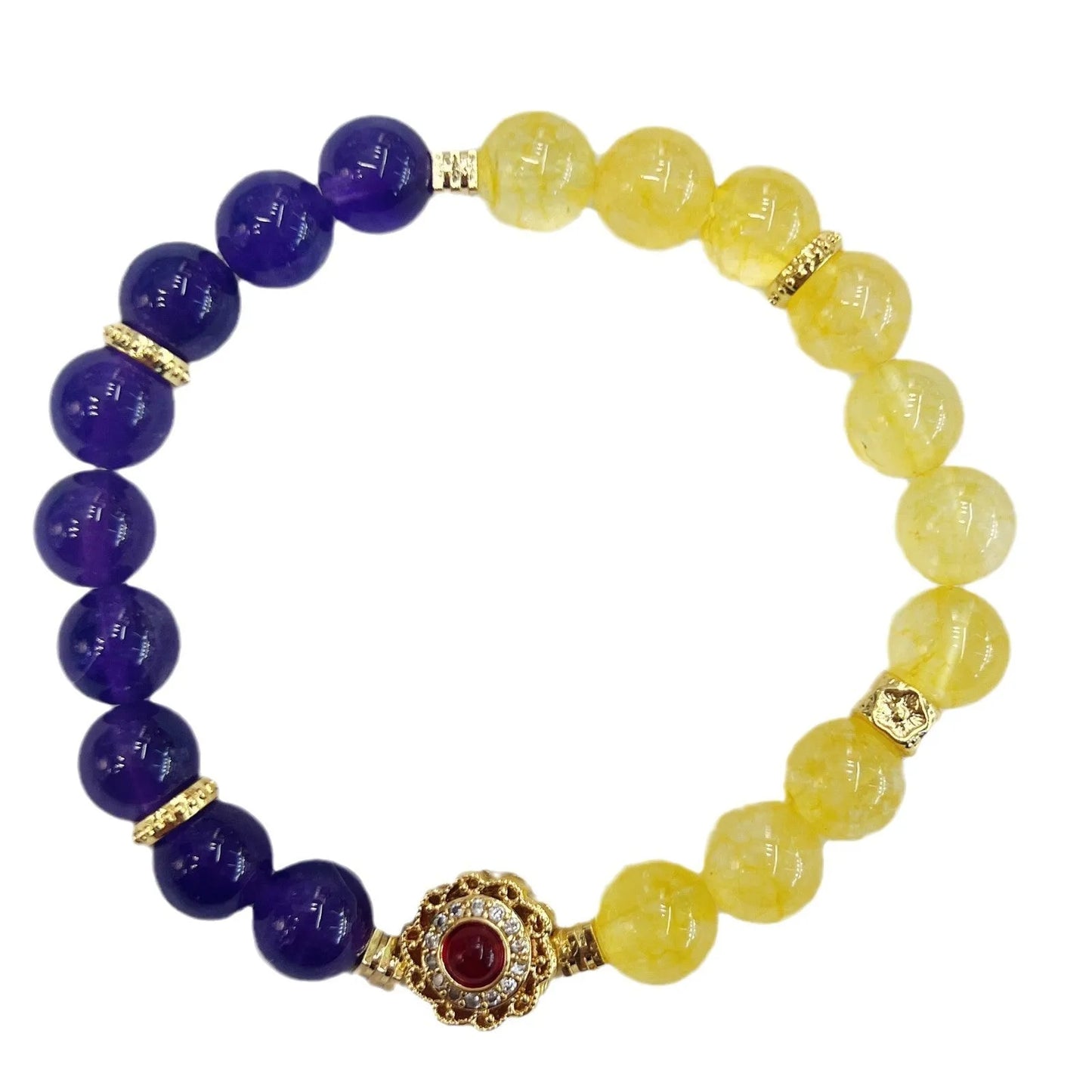 Handmade women's crystal bracelet in yellow and purple colours on a wrist.