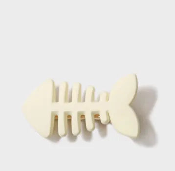 Minimalist fishbone pattern duckbill hair barrette in neutral colours on a white background.