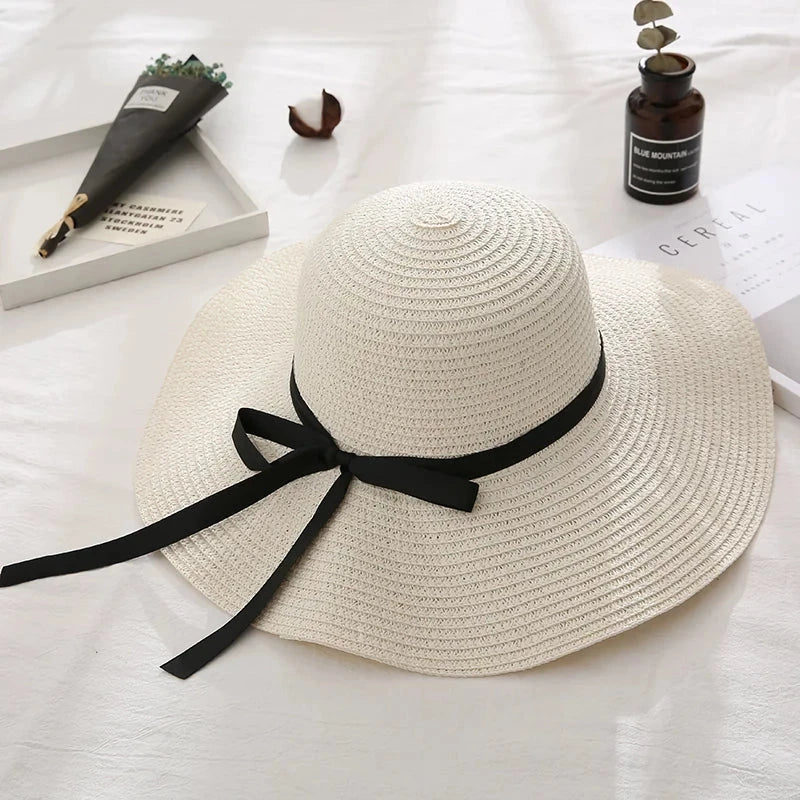 Fashionable summer straw hat for women with wide brim and bow detail, providing UV protection and stylish look