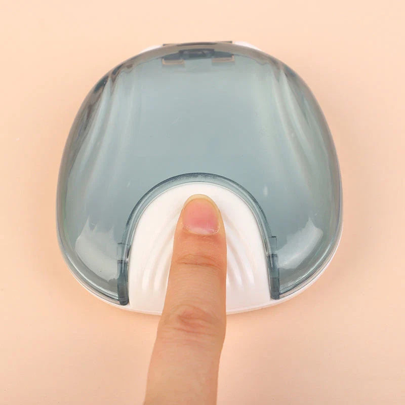 Compact, transparent dental retainer storage box with a push-to-open mechanism for easy access to dental appliances