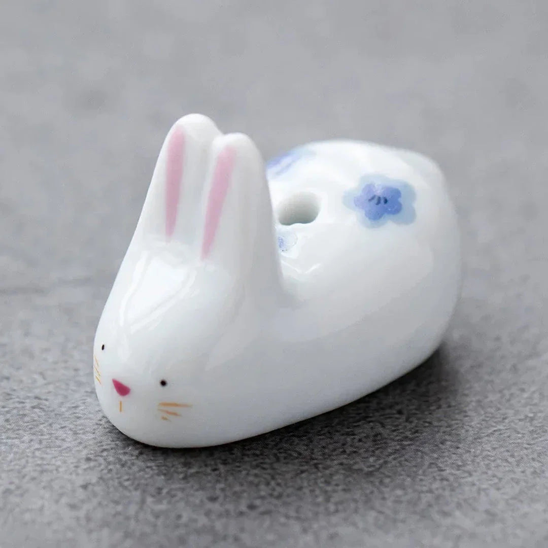 Charming ceramic incense holder featuring a cute rabbit and kitten design, perfect for adding a touch of whimsy and tranquility to any room.