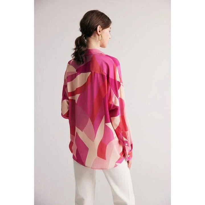 Elegant silk crepe de chine blouse in a unique print design, featuring a loose, straight fit and full-length drop sleeves for a modern, sophisticated look.