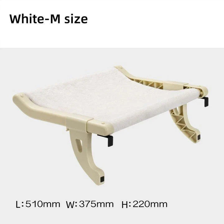 Cat relaxing in a cozy, hanging hammock bed placed in a sunny window