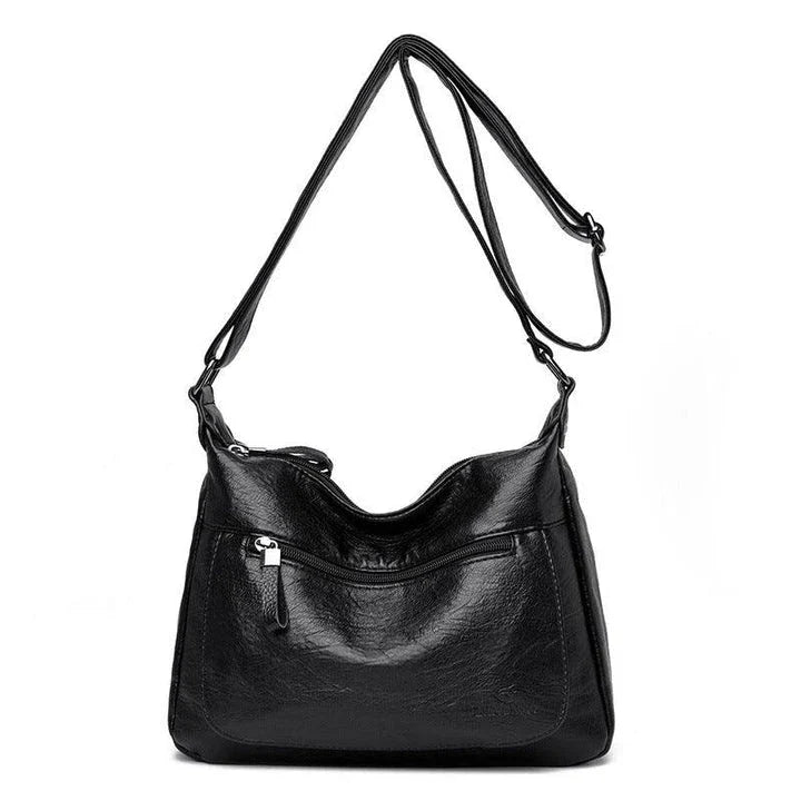 Stylish one-shoulder messenger bag in various colors with a soft, supple PU leather exterior and a spacious, organized main compartment