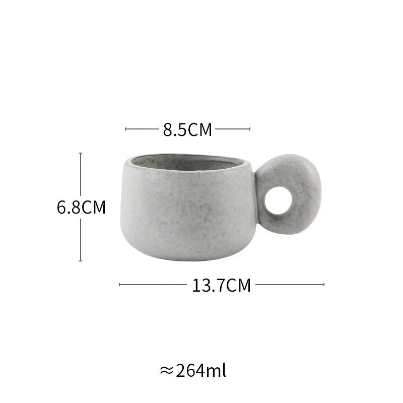 Handcrafted Japanese stoneware retro coffee mug in apricot and grey colors with a comfortable grip and minimalist design