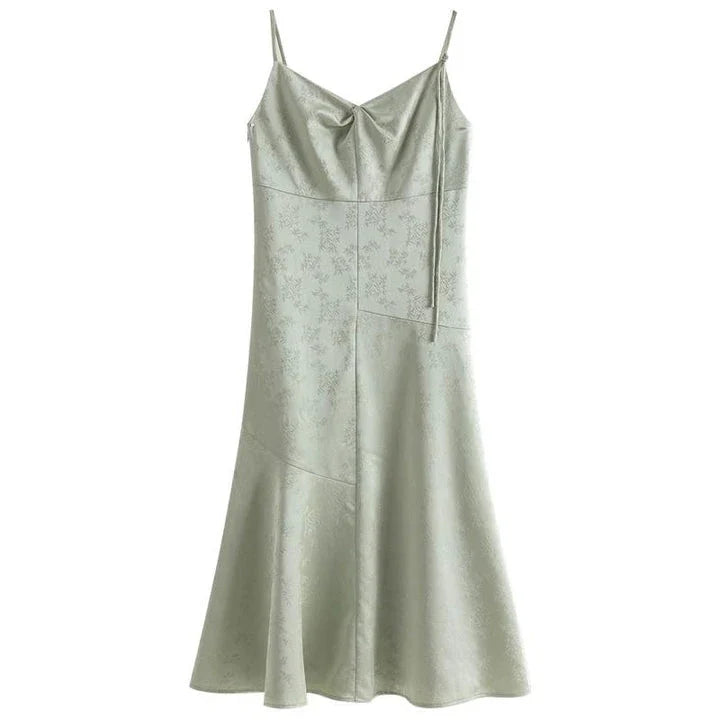 Elegant mint green midi dress with spaghetti straps, featuring a slim fit and intricate embroidery details