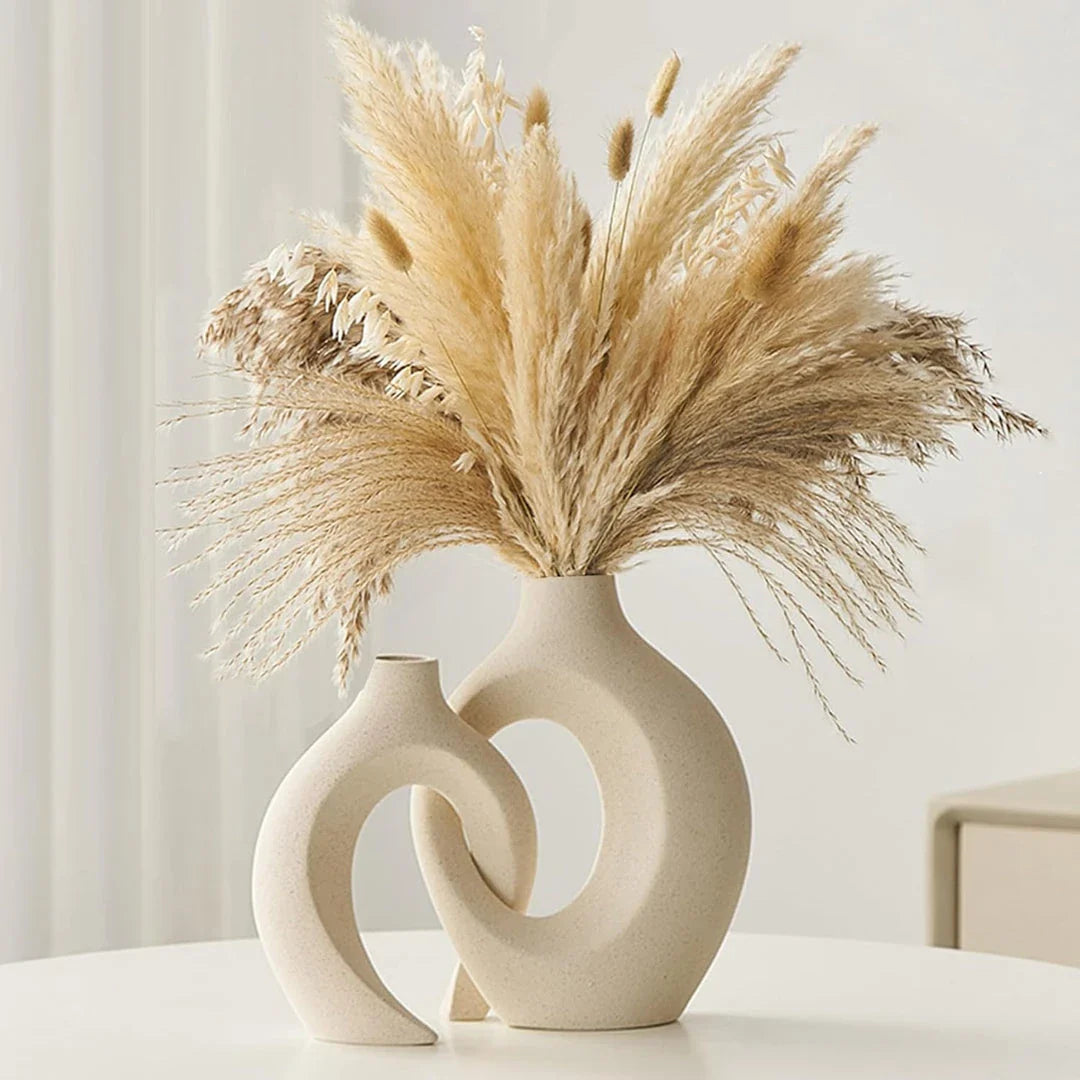 A set of two modern, minimalist white ceramic vases with a textured finish, designed to elevate any home decor.