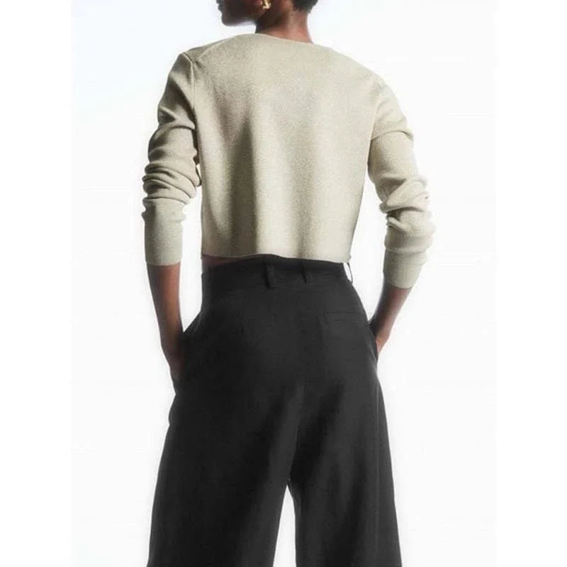A cozy and chic v-neck cardigan in a classic solid color, featuring a slim, flattering fit and elegant button detailing for versatile autumn and winter wear.