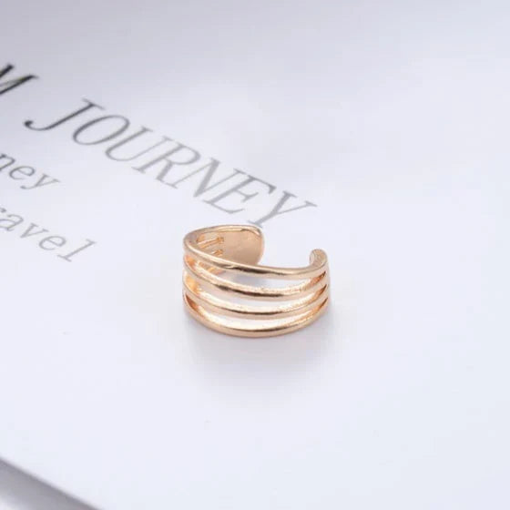 Elegant multilayered ear cuff in a lustrous golden tone, offering a stylish and versatile accessory for chic looks.