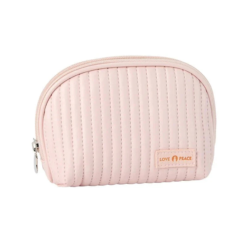 Stylish compact makeup bag made of premium PU leather in light blue color, with a sleek minimalist design for modern women