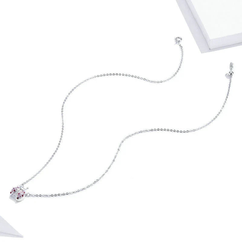 A sterling silver necklace featuring a charming ladybug design, with an adjustable chain for a customized fit.