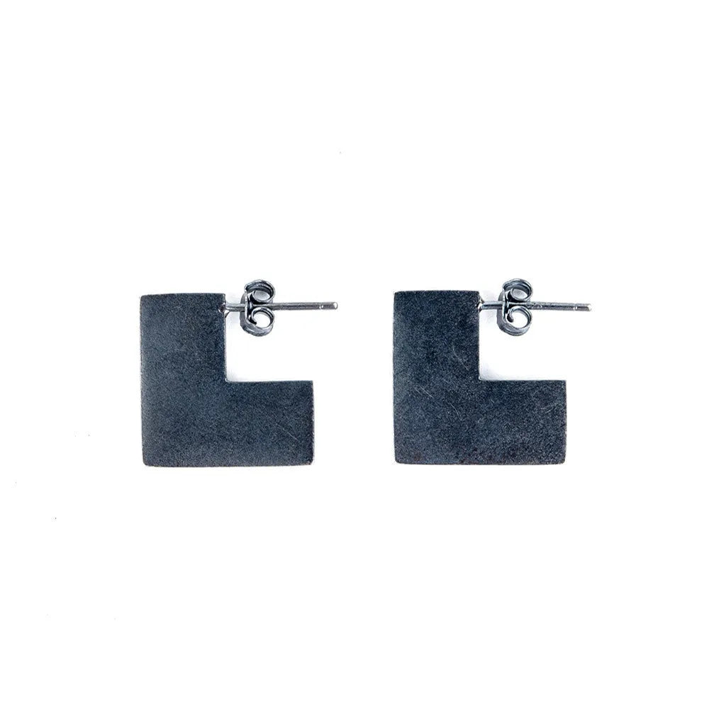 Oxidised black sterling silver earrings with a geometric square shape and minimalist ring design.