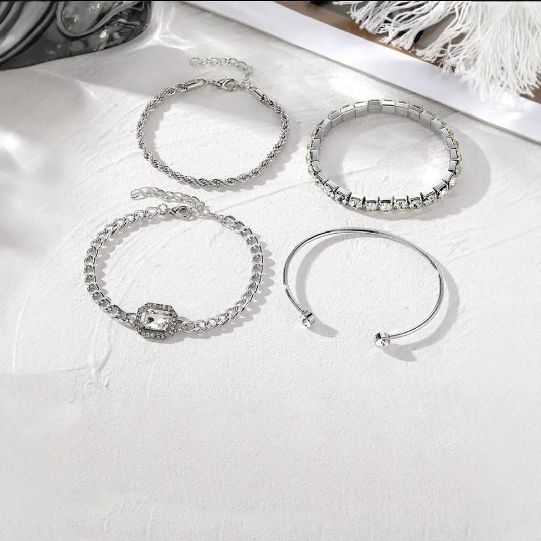 Women's four-piece alloy jewellery set with geometric square diamond shapes and chain links in gold finish