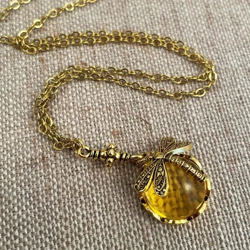 Vintage bronze dragonfly pendant necklace on a chain, yellow finish, pastoral style.