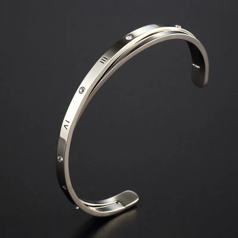 Women's open-ended stainless steel bracelet with a central inlaid zircon stone in rose gold colour.