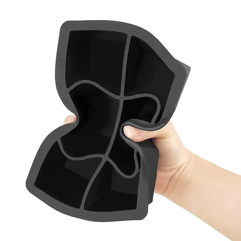 A silicone ice cube maker with 6 grid slots to produce large, round and square ice cubes for chilling whiskey, cocktails, and other beverages.