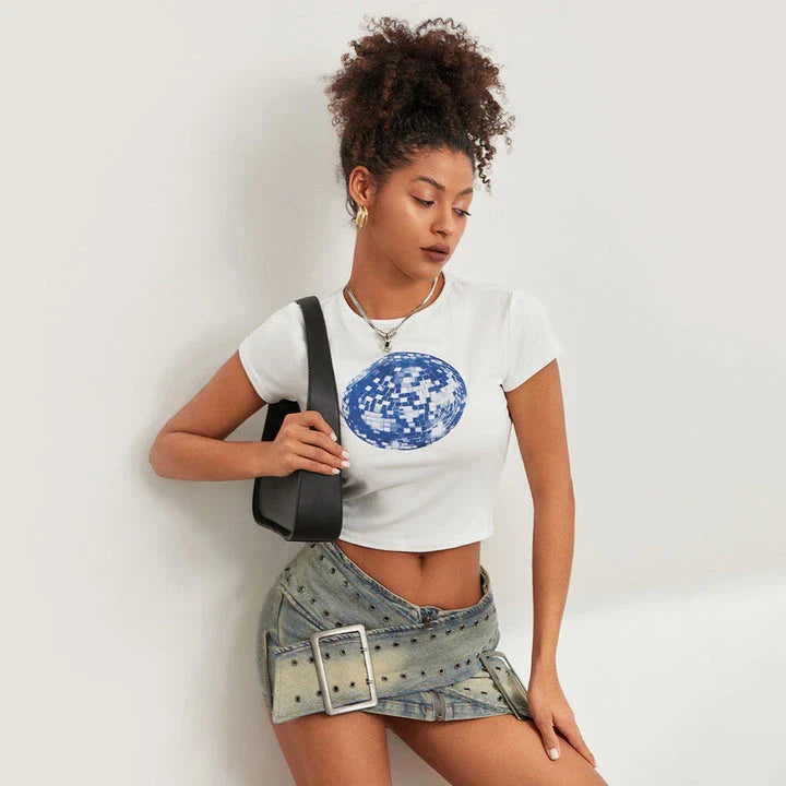 A white t-shirt with a vibrant floral and disco ball print, perfect for adding a fun twist to your summer wardrobe.