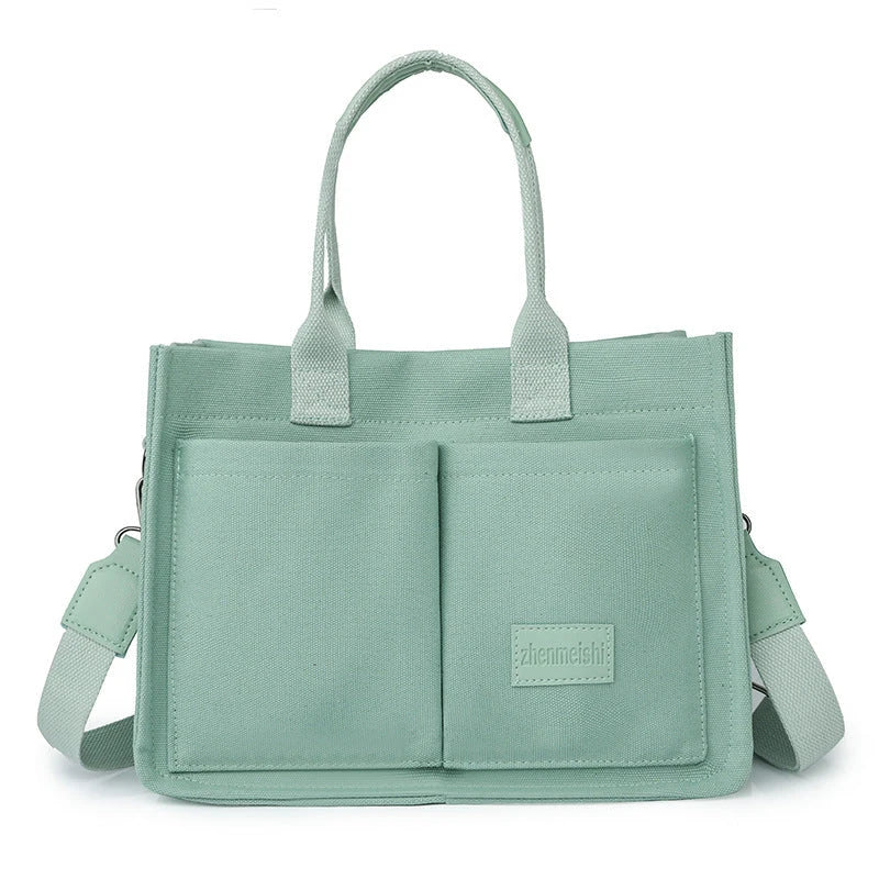 Premium canvas tote bag in multiple colors with adjustable shoulder strap and organizational pockets