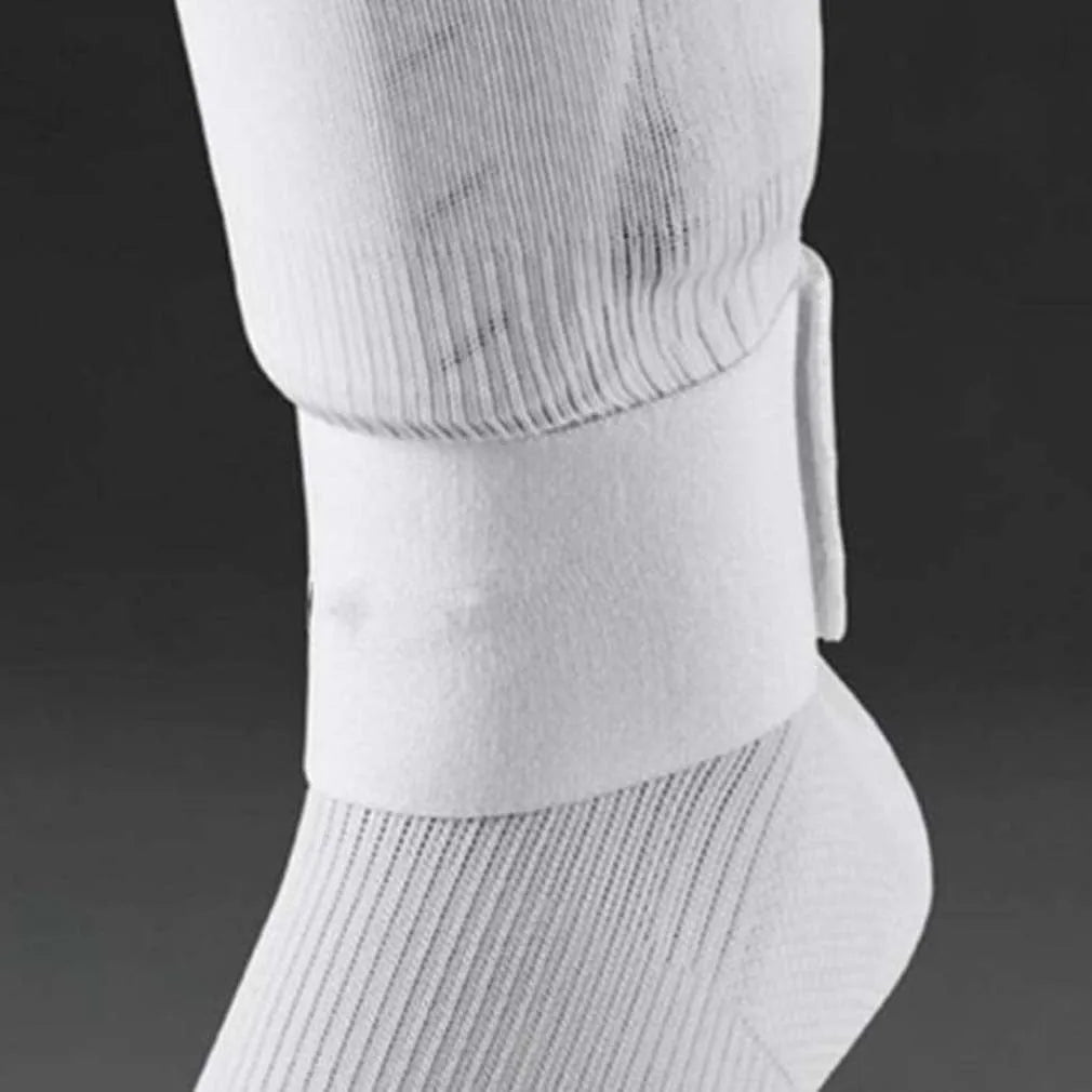 Rubber shin guard strap for football in red, shown securing a shin pad.