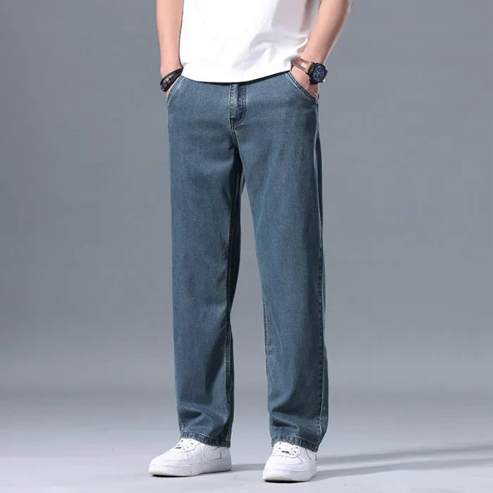 Man wearing light blue loose-fit straight-leg lyocell blend casual jeans.
