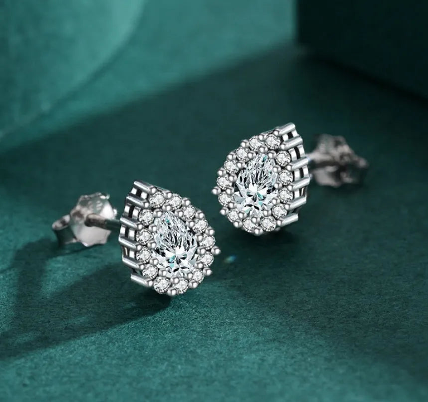 A pair of women's silver drop-shaped ear studs with a polished finish on a white background.