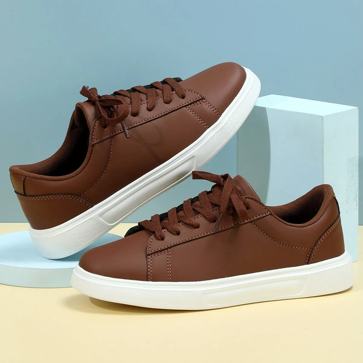 Beige brown women's low-top platform casual sneakers with a cross strap and round toe on a white background.