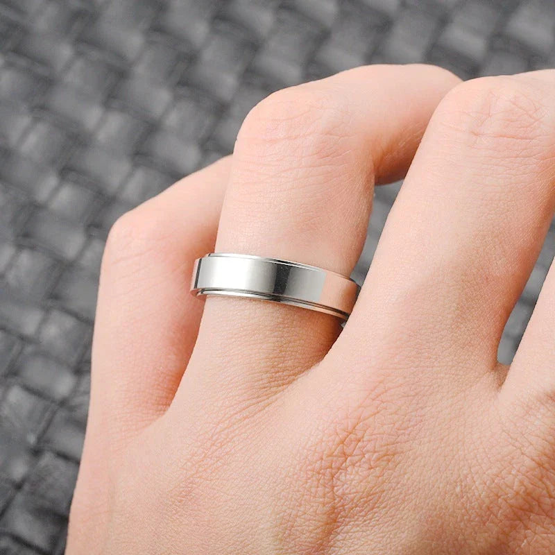 Stainless steel spinner ring with intricate moon and stars design