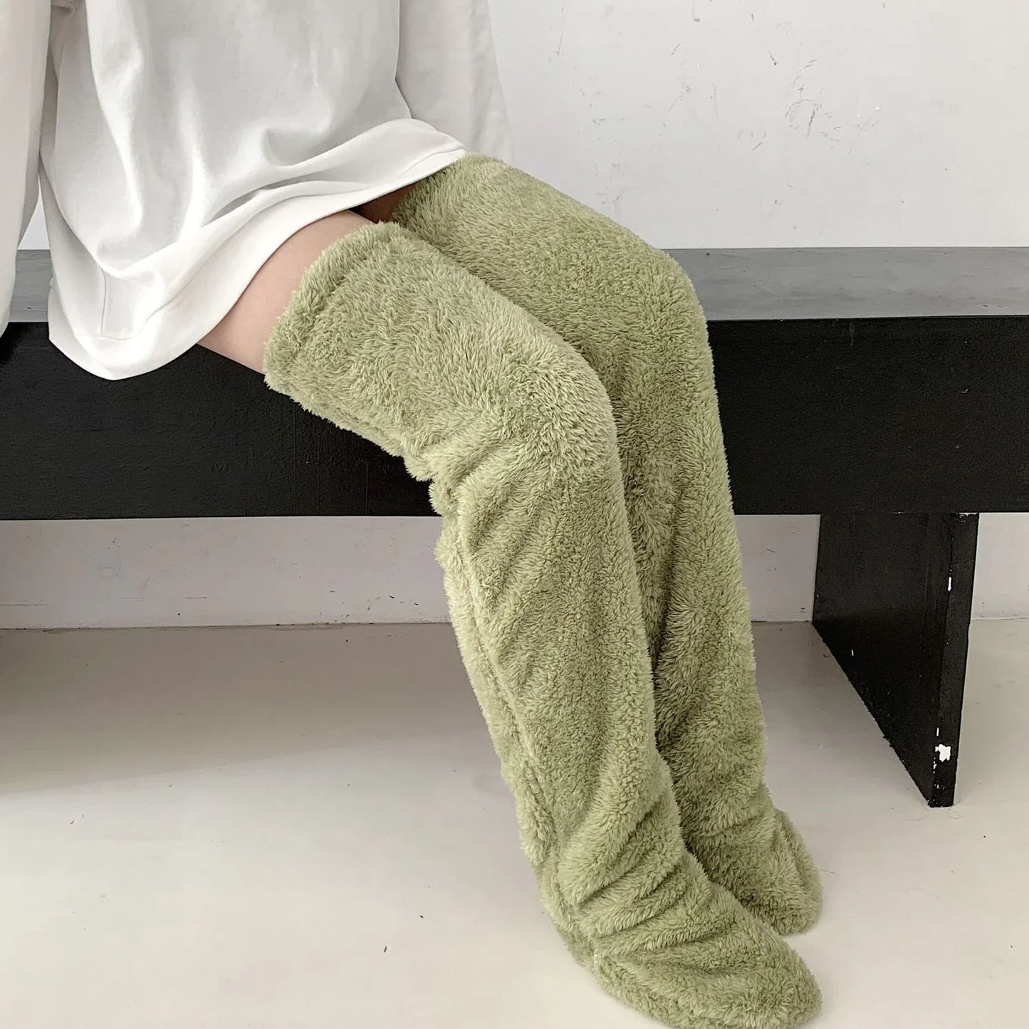 Cozy over-the-knee fuzzy socks in various colors, including brown, blue, dark gray, pink, silver, and more. Comfortable cotton design for warm, snug legs.