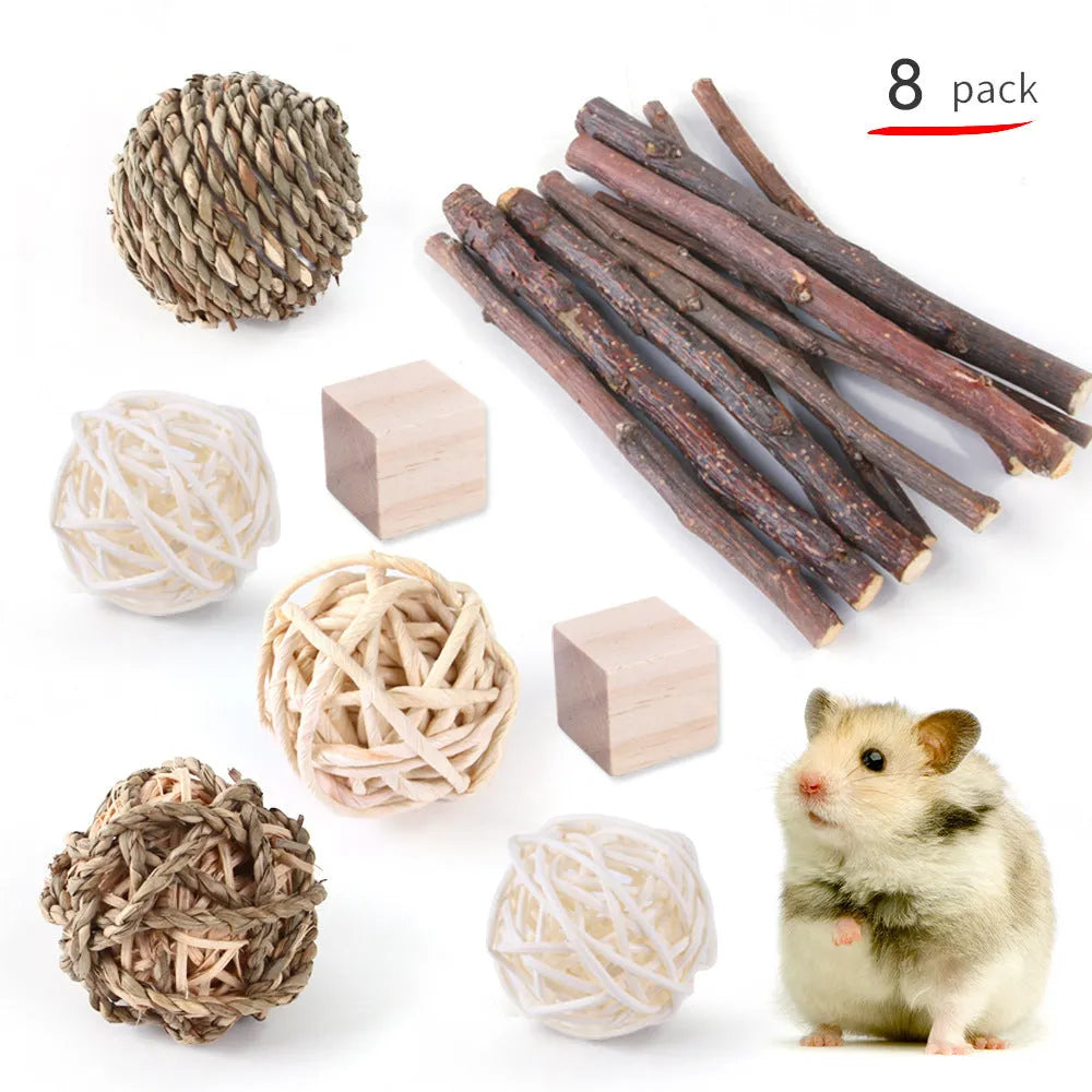 Assortment of wooden and natural fibre chew toys for small pets including balls, rings and woven shapes.