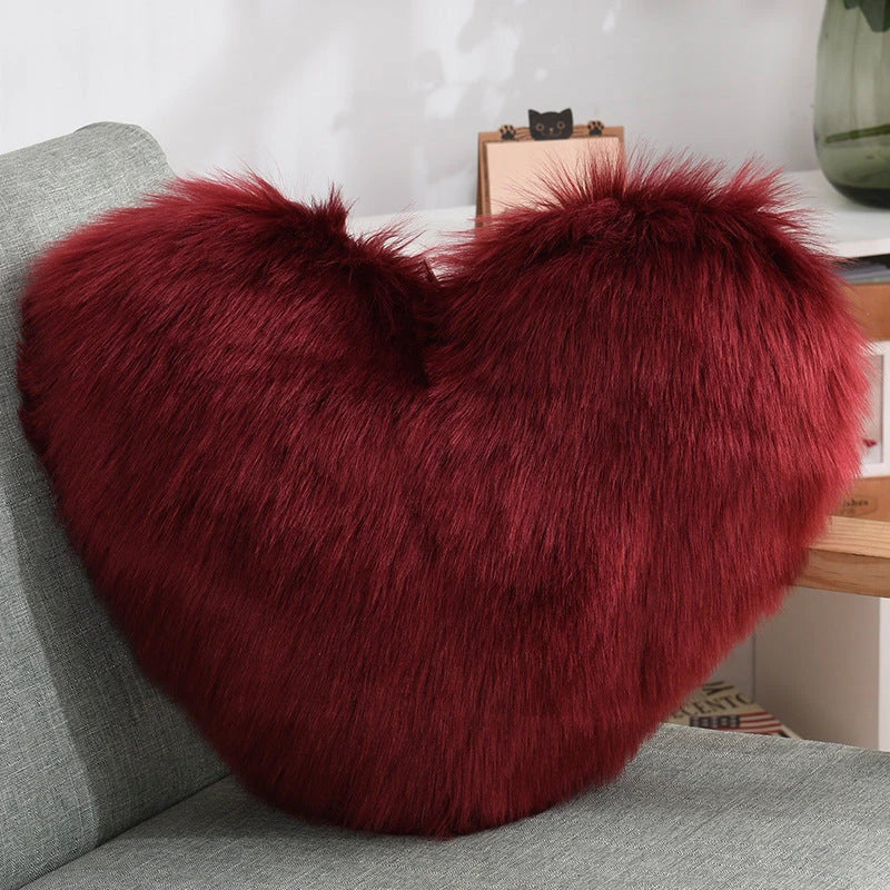 Cozy heart-shaped plush throw pillows in various colors and sizes for living room and bedroom decor