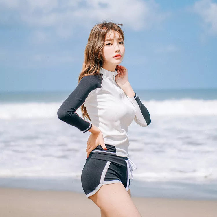 Couple in blue split swimsuits snorkeling in clear water