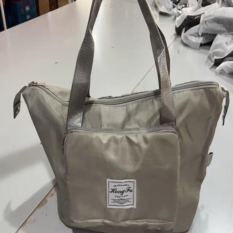 Versatile foldable travel bag with large 36-55L capacity, multiple interior pockets, and water-resistant Oxford cloth construction