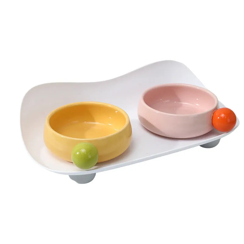 Ceramic raised pet bowl set with two bowls and non-slip base in pink, yellow and pink-yellow colours